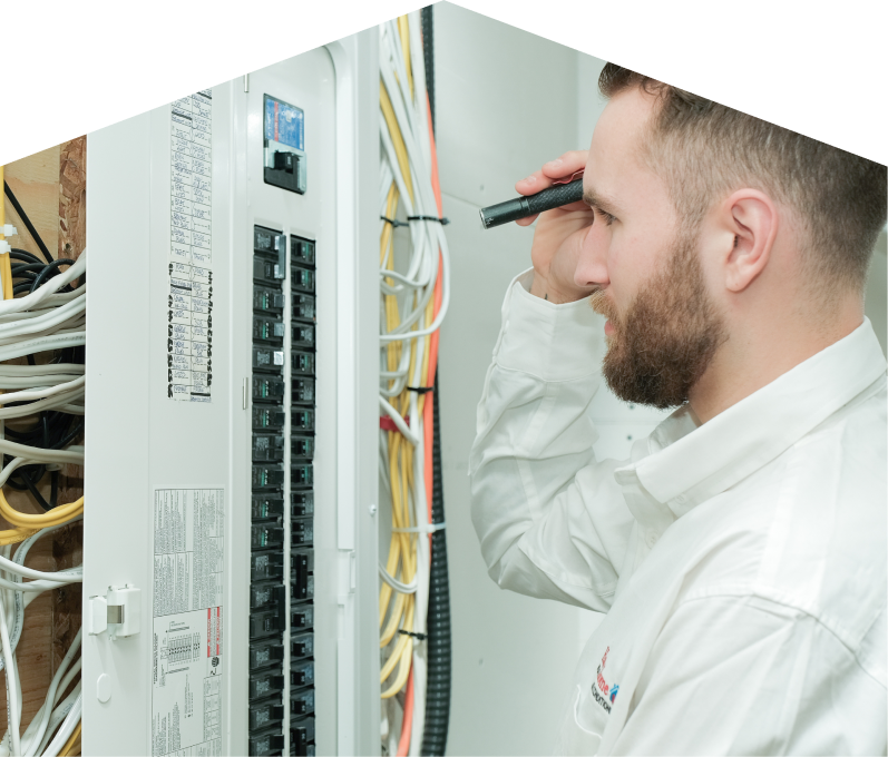 Francis electrician inspecting residential electrical panel wiring with a flashlight, checking connections and circuit labels. Francis electrician inspecting residential electrical panel wiring with a flashlight, checking connections and circuit labels.