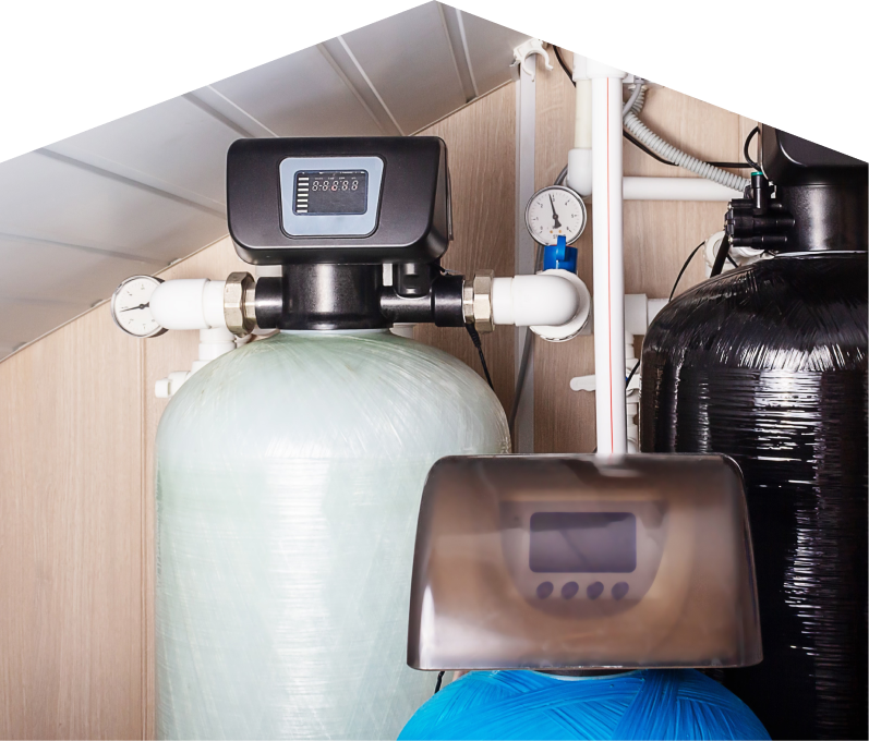 Francis home water filtration system featuring resin tanks, digital control heads, pressure gauges, and connected piping in a utility room. Francis home water filtration system featuring resin tanks, digital control heads, pressure gauges, and connected piping in a utility room.